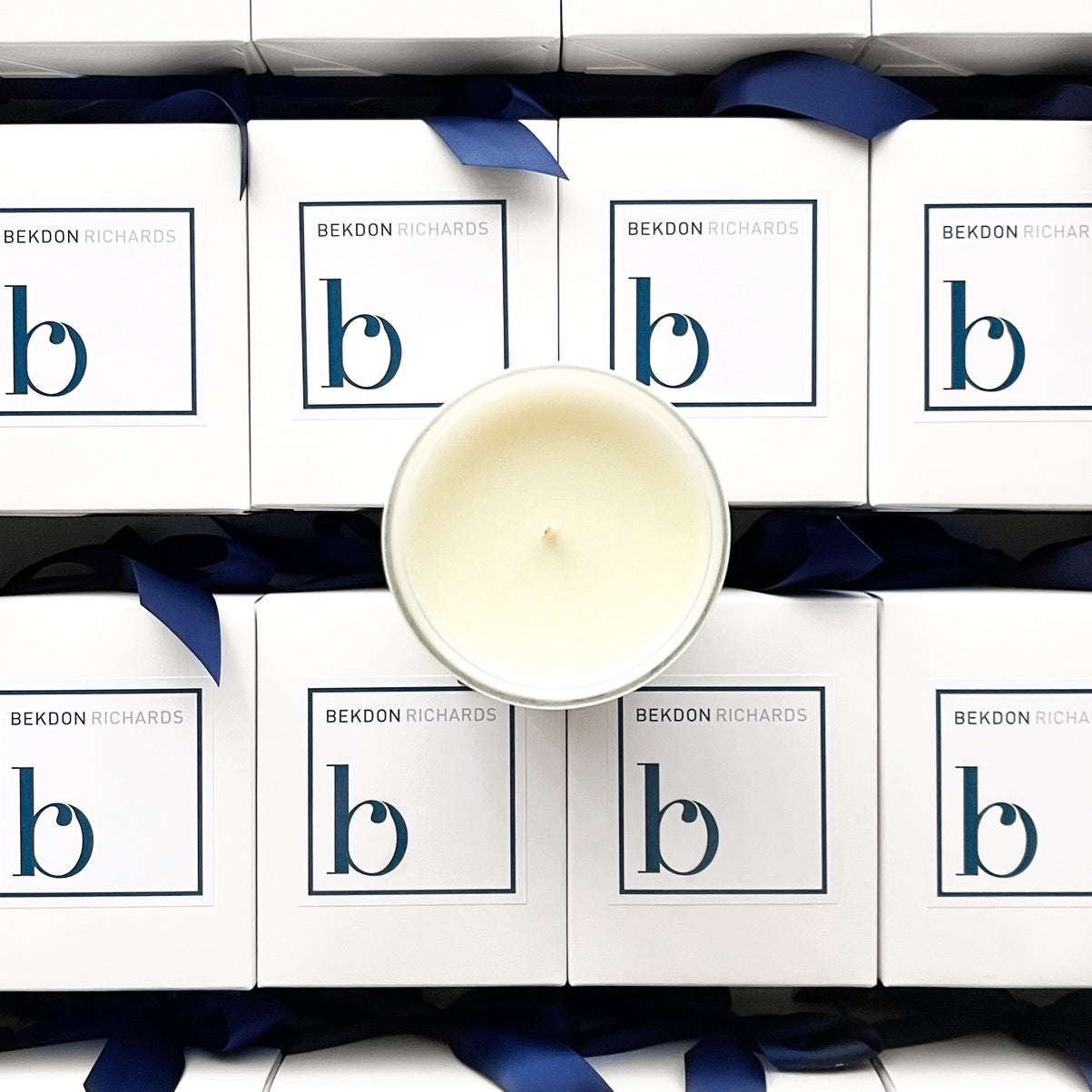 Large 300g Custom Branded Candle for Bekdon Richards. Hand poured and presented in luxe white packaging with navy ribbon, perfect for real estate gifting.