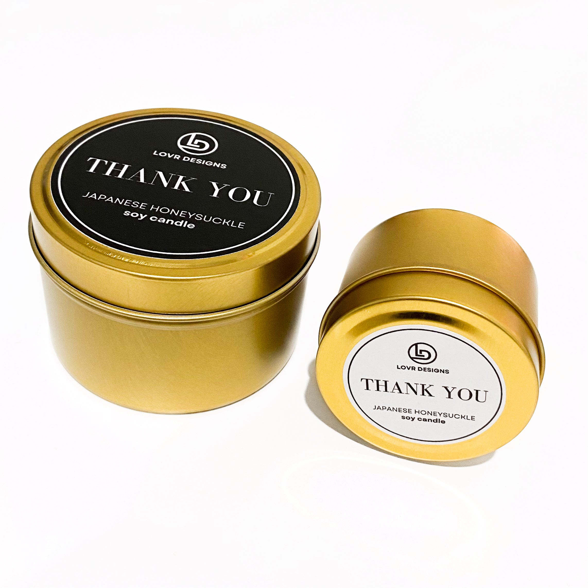 Gold tin candles with 'THANK YOU' labels in black and white, Japanese Honeysuckle fragrance by Lovr Designs.