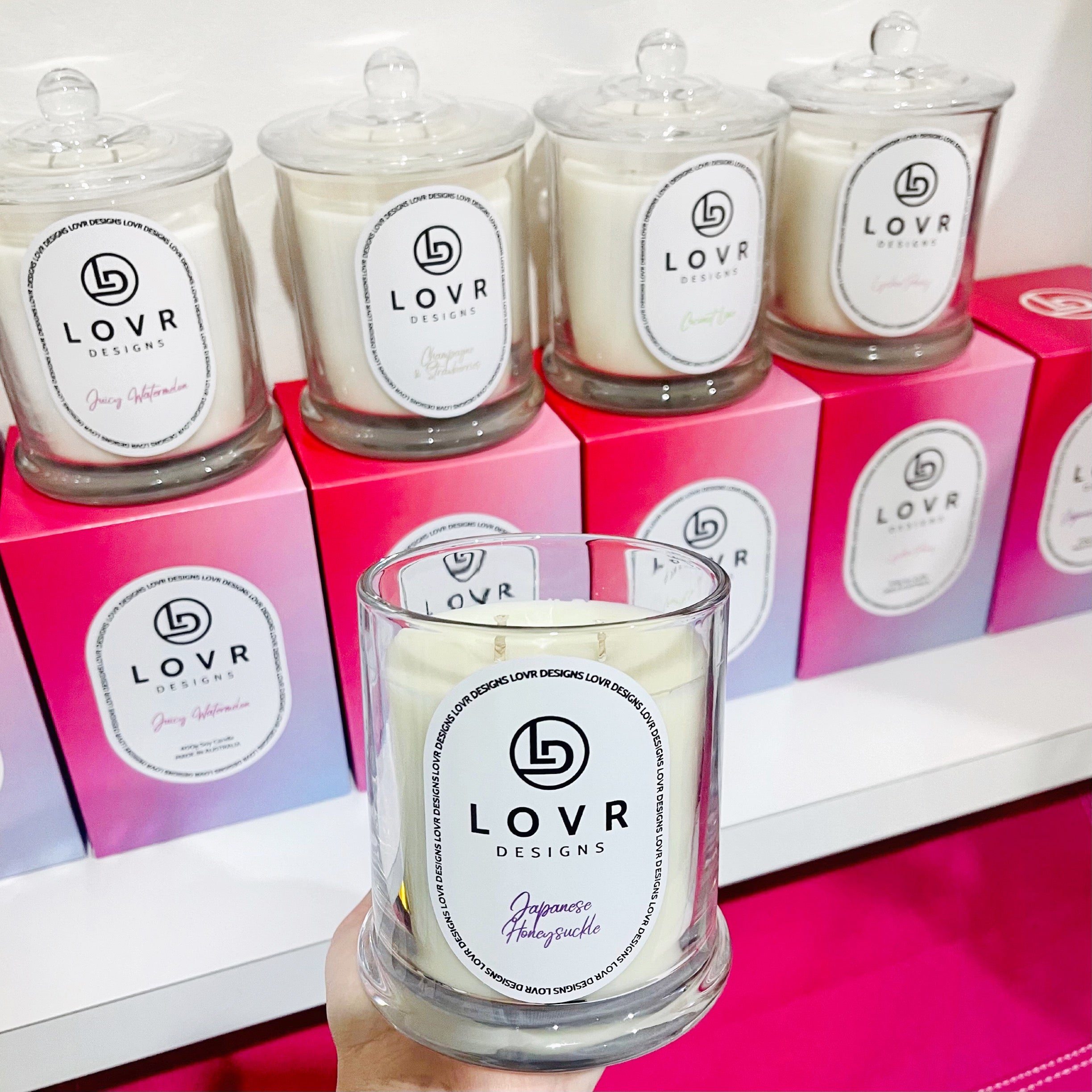 Lineup of Lovr Designs Signature Collection 400g Scented Soy Candles with gift boxes – includes Japanese Honeysuckle, Coconut, and Watermelon scents.