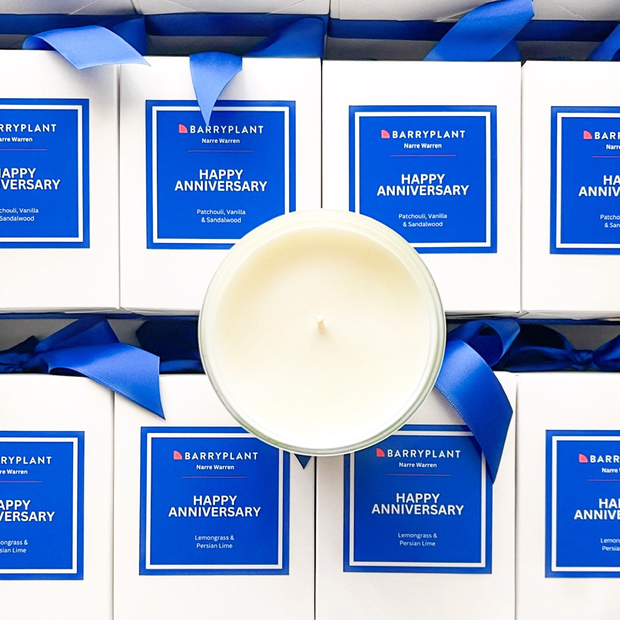 300g Happy Anniversary Custom Branded Candles for Barry Plant Narre Warren. Elegant soy candles in Lemongrass & Persian Lime and Patchouli, Vanilla & Sandalwood, hand packaged with bright blue ribbon.