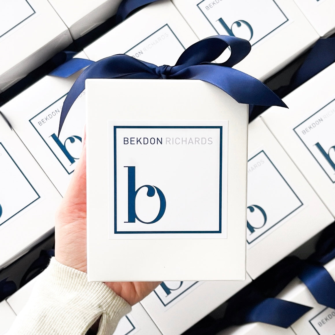 Custom branded 300g candle for Bekdon Richards Real Estate with navy blue and silver logo, perfect for property settlement gifts.