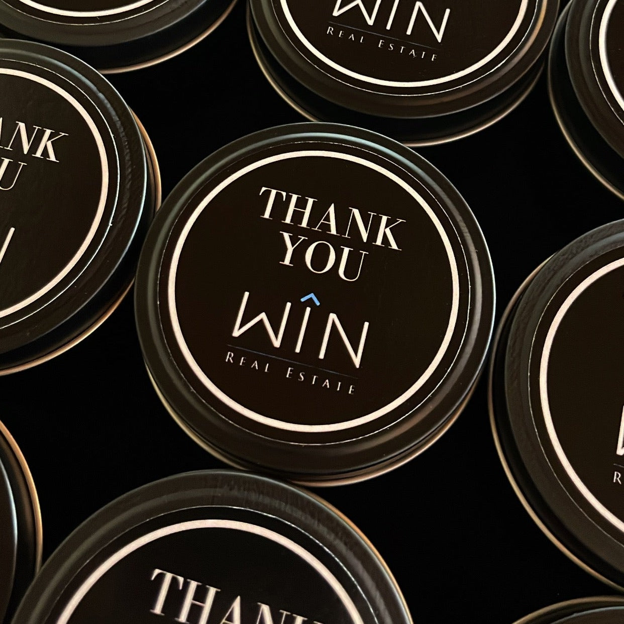 Custom Branded Candle Tin for WIN Real Estate featuring thank you message on sleek black label