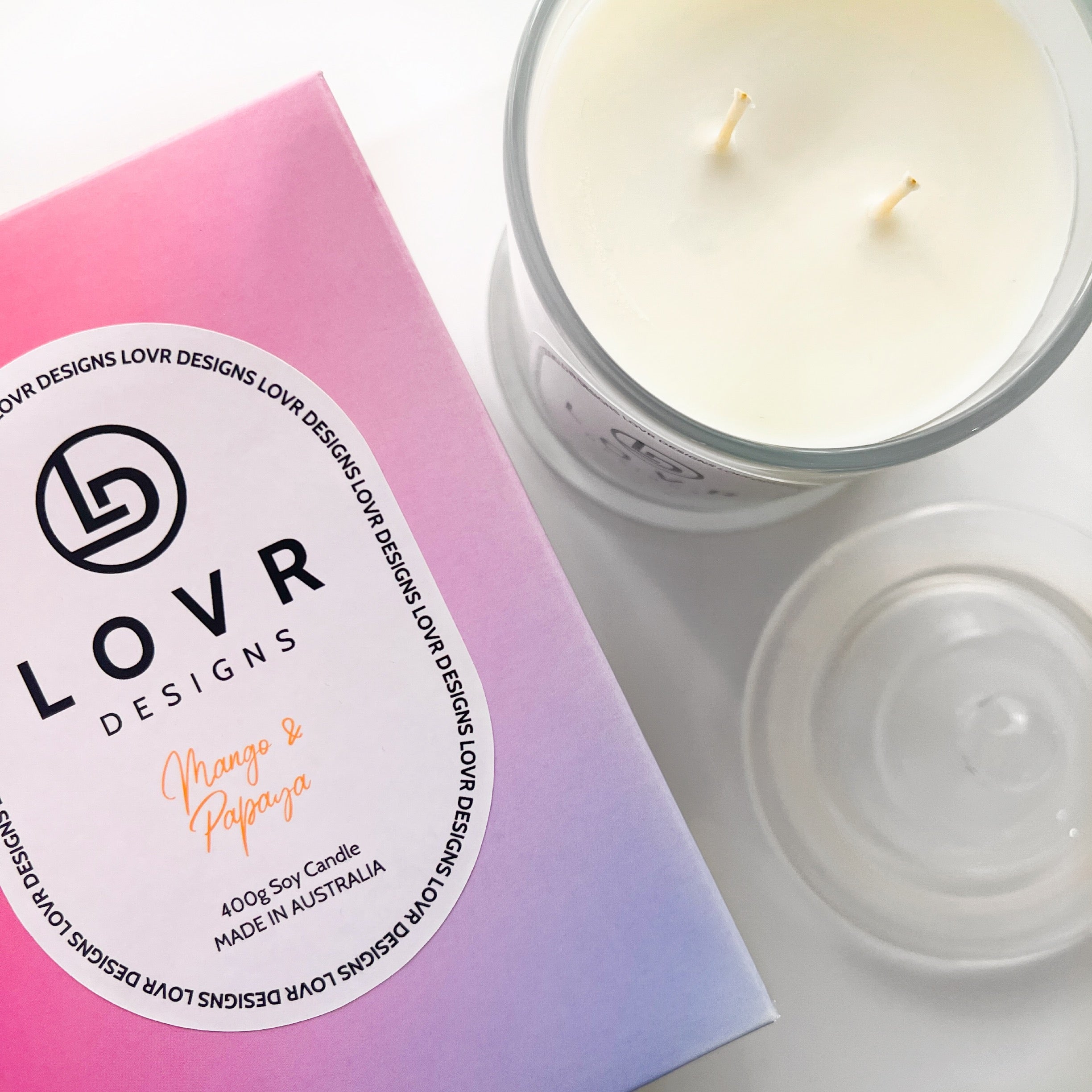 Flatlay of Mango & Papaya candle with open jar and gradient gift box – Lovr Designs