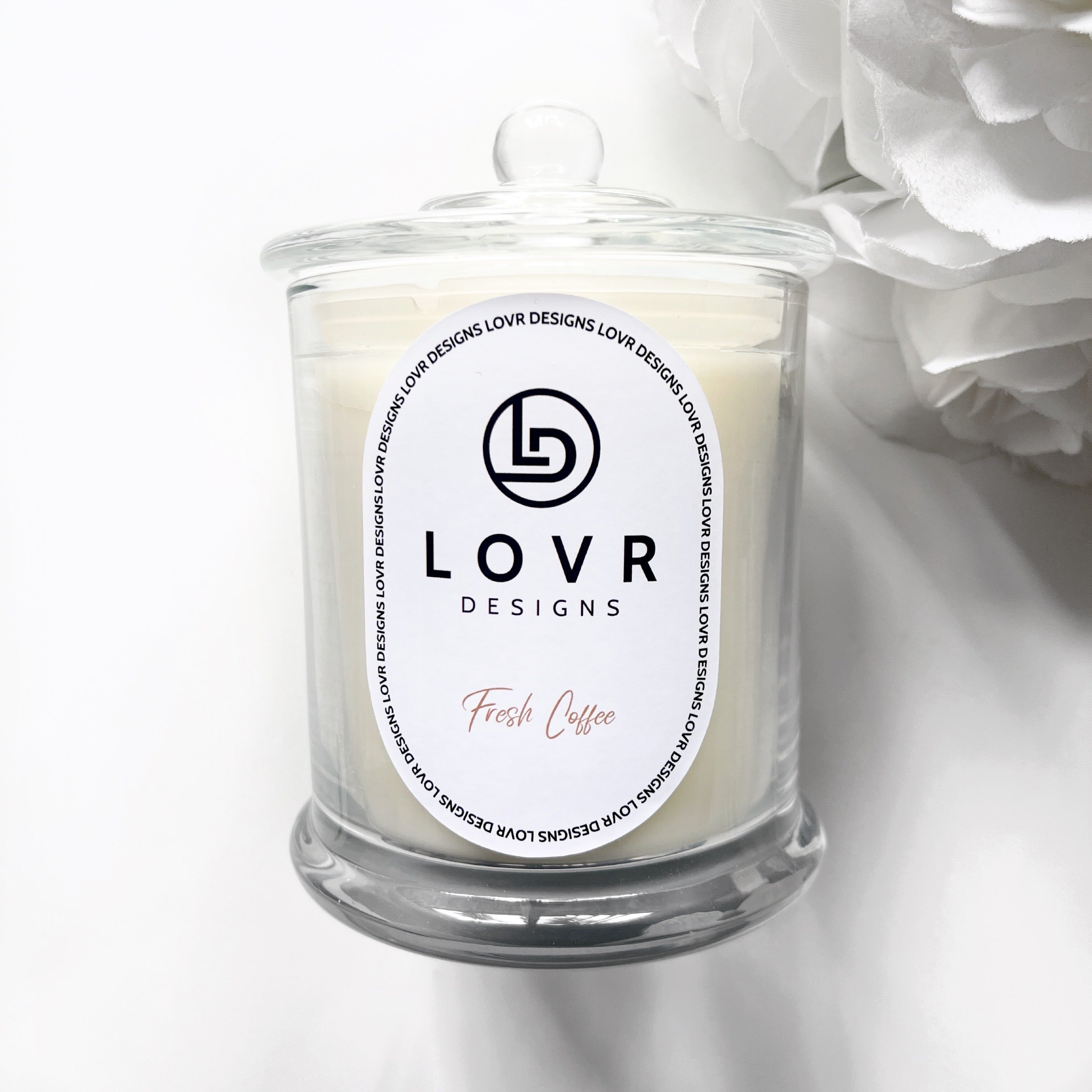 Fresh Coffee scented soy candle by Lovr Designs styled with white flowers on a soft white background.