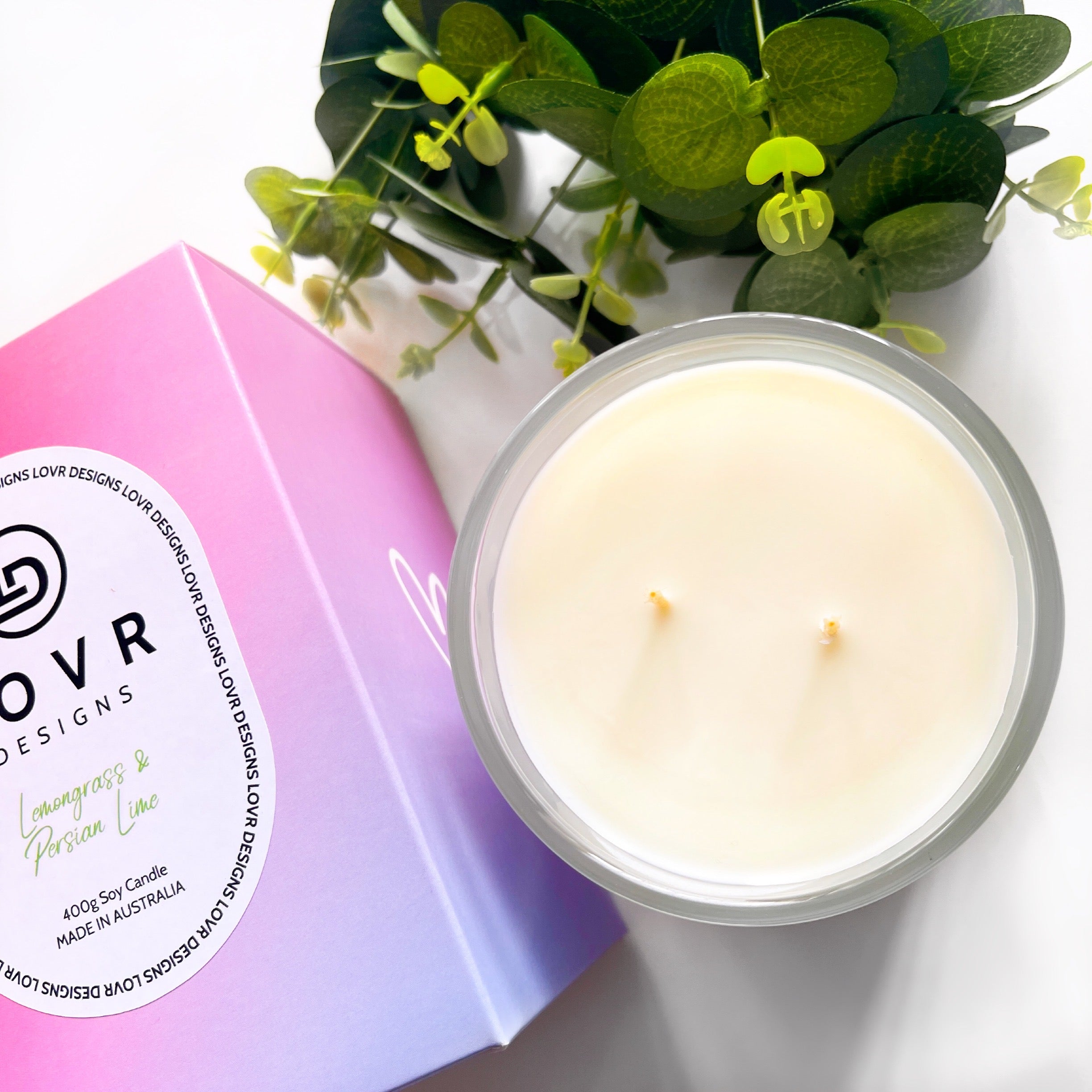 Lemongrass & Persian Lime scented soy candle with lid off and greenery – 400g Lovr Designs Signature Candle
