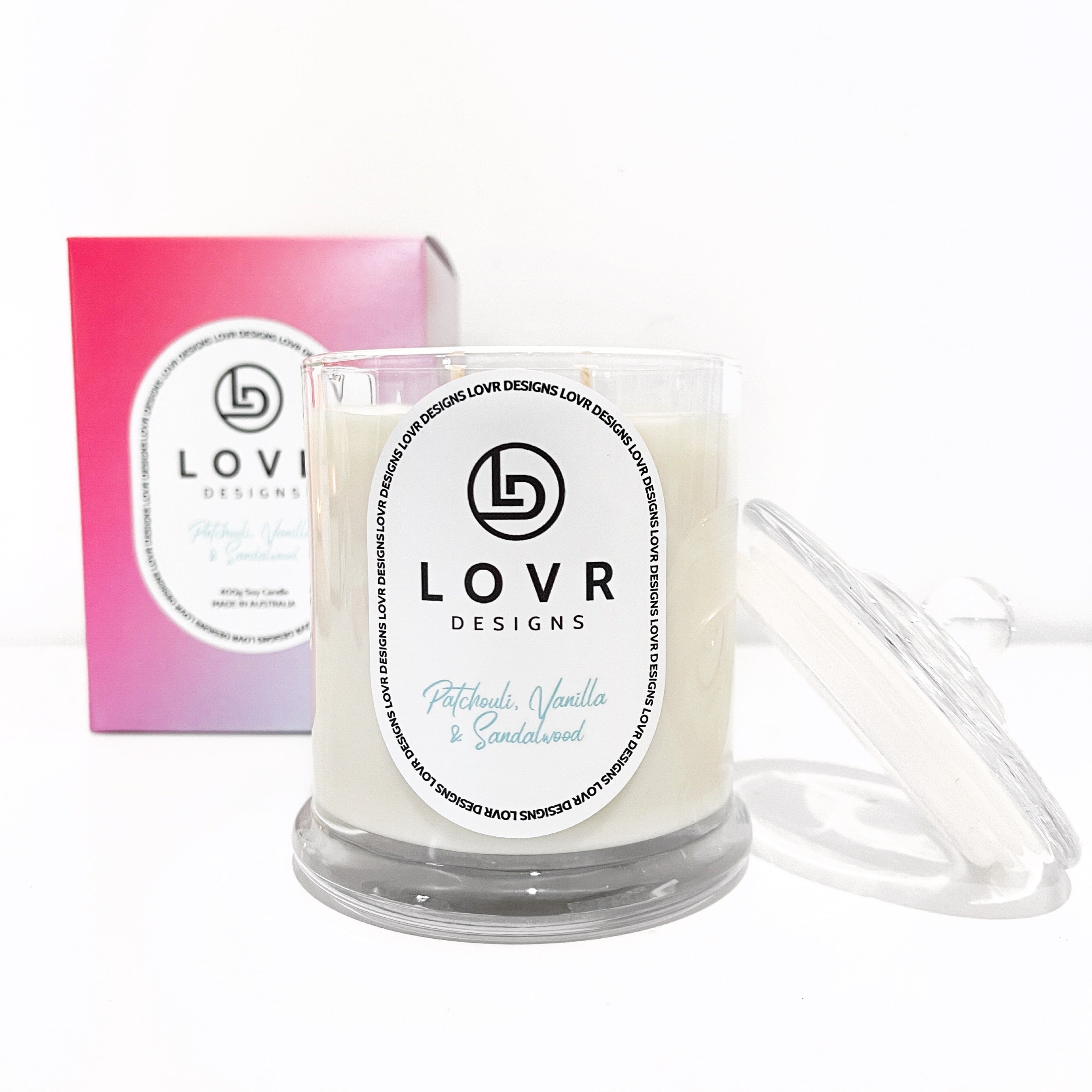 Lovr Designs Patchouli, Vanilla & Sandalwood Candle with lid off and gift box in background